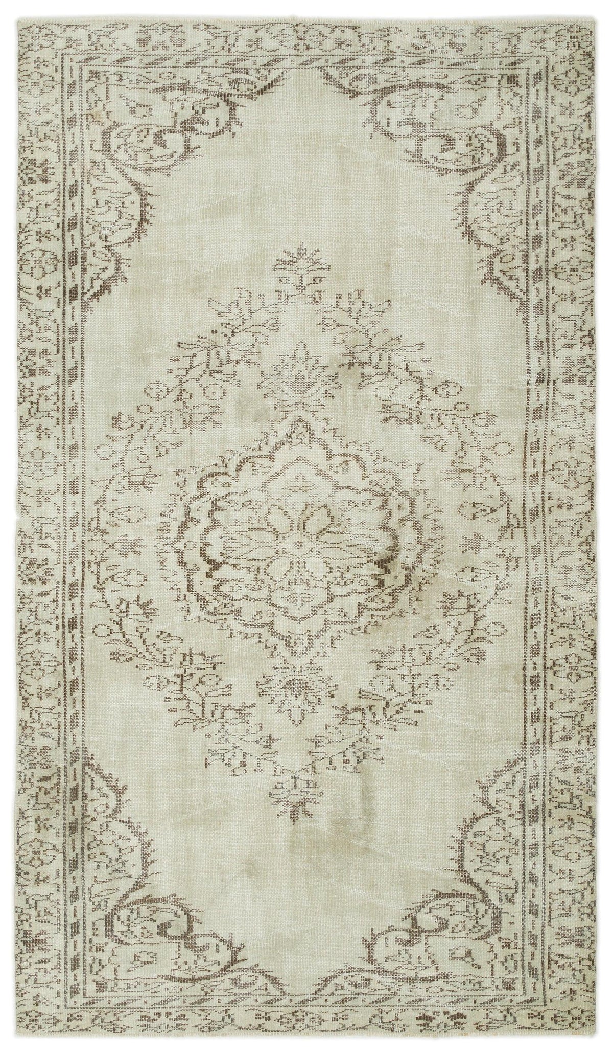Beige and brown distressed rug with a central floral medallion and ornate border pattern.