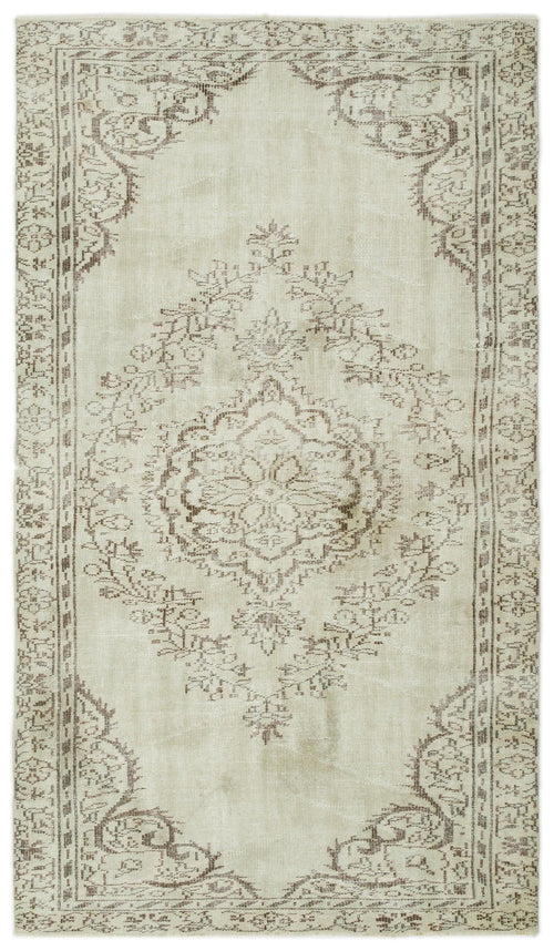 Load image 1 in gallery view. Beige and brown distressed rug with a central floral medallion and ornate border pattern.