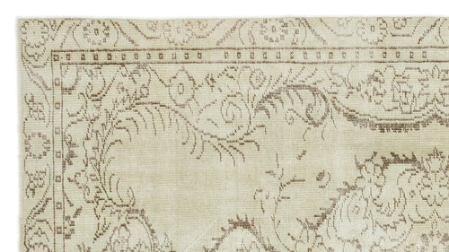 Load image 1 in gallery view. Beige and taupe rug with a distressed floral vine pattern and a geometric border.