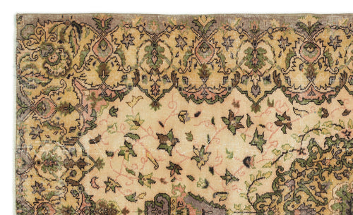Load image 1 in gallery view. Beige vintage-style rug with a distressed floral medallion pattern in muted green, pink, and brown tones.