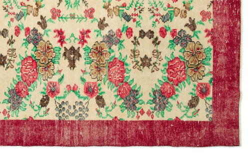 Load image 1 in gallery view. Cream rug with a floral pattern in red, green, and brown, featuring a wide solid red border.