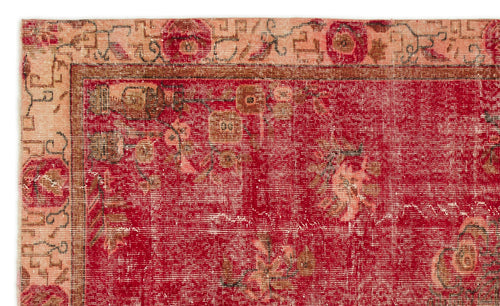 Load image 1 in gallery view. Red and peach vintage-style rug with a distressed floral medallion pattern and a decorative geometric border.