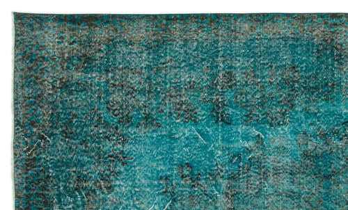 Load image 1 in gallery view. Teal and black distressed rug with a faded, vintage-inspired floral pattern.
