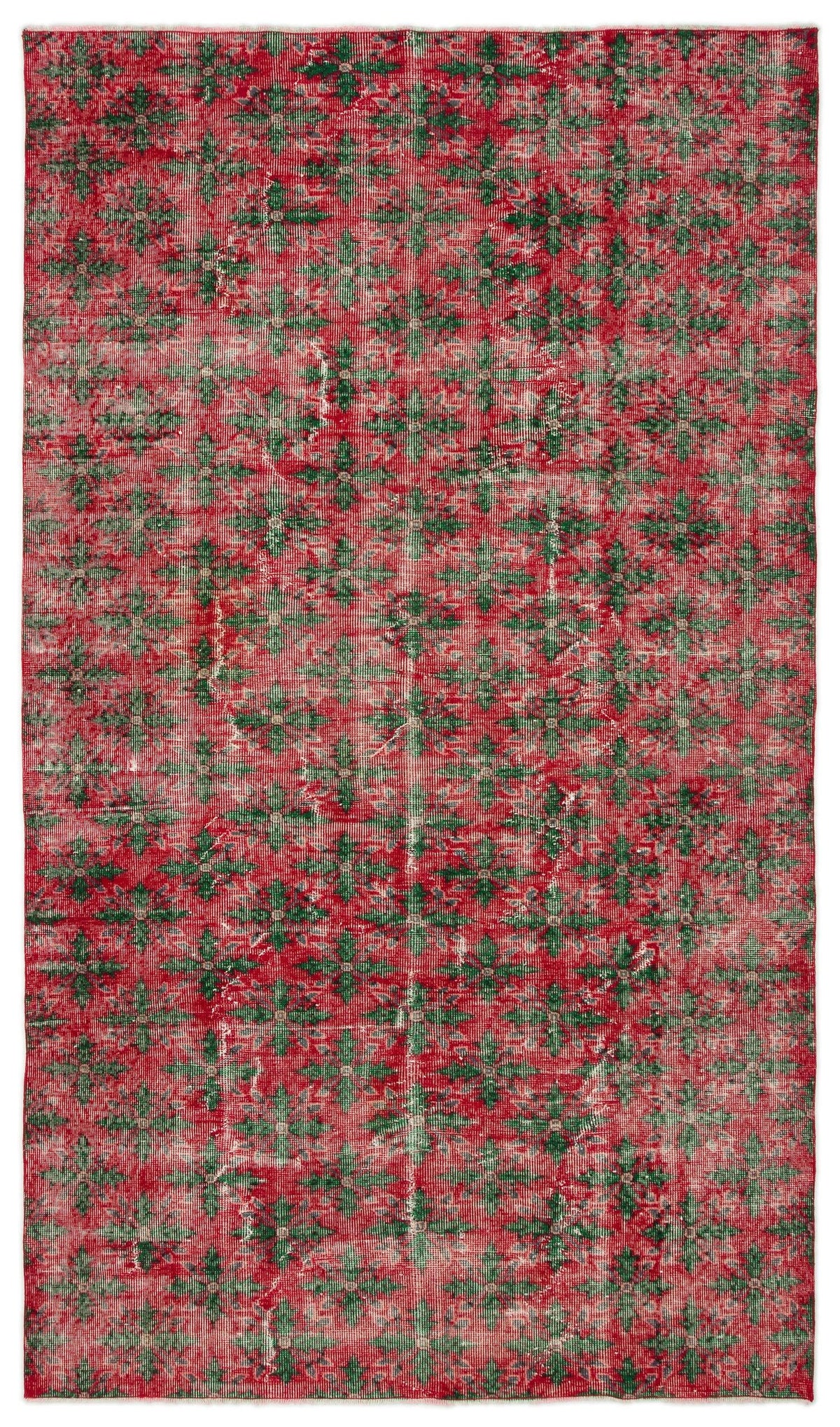 Red and green distressed vintage-style rug with an all-over geometric floral pattern.