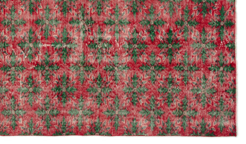 Load image 1 in gallery view. Distressed red and green rug with a repeating geometric floral medallion pattern.