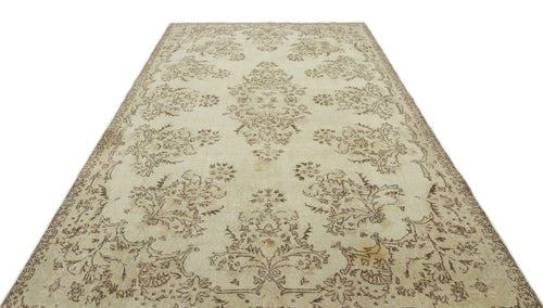 Load image 1 in gallery view. Cream and beige vintage-style rug with a distressed floral medallion pattern on a white background.