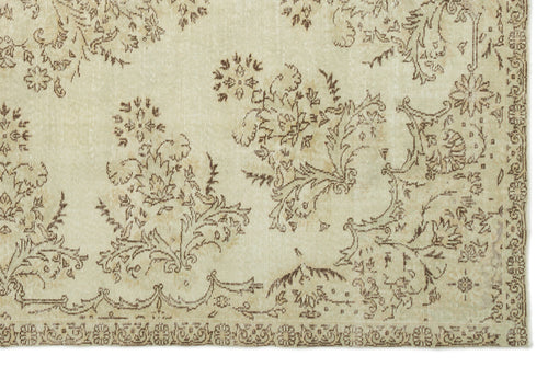 Load image 1 in gallery view. Beige and brown vintage-style rug with a distressed floral pattern and a decorative border.