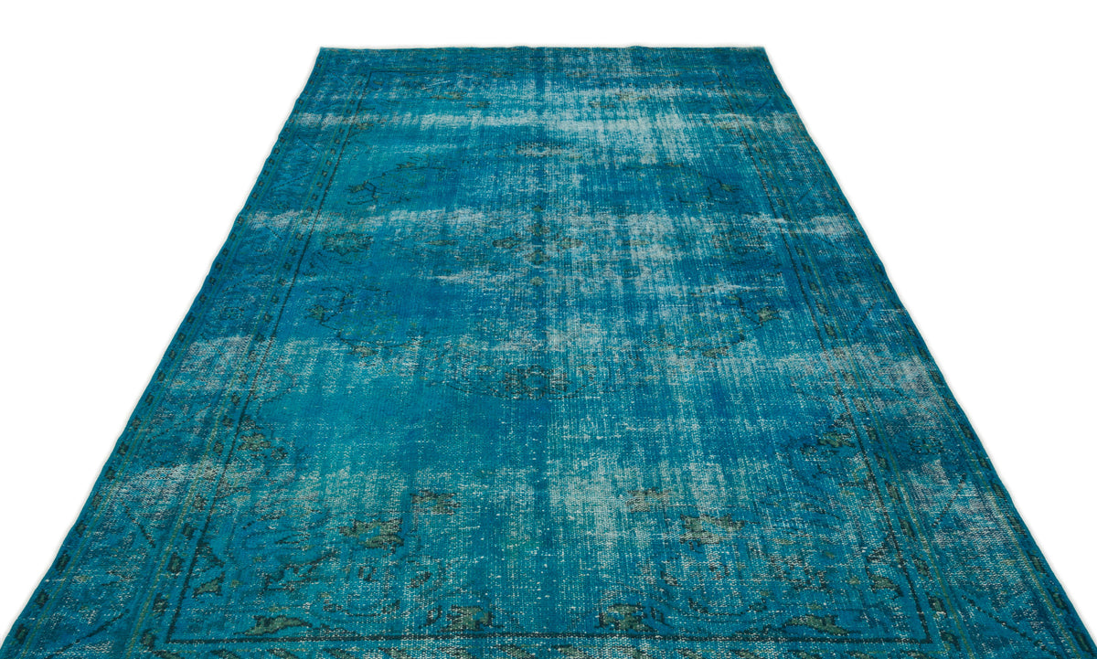 Teal and blue distressed vintage-style rug with a faded traditional medallion pattern on a white background.