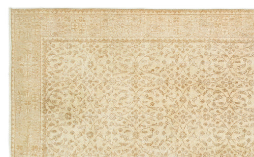 Load image 1 in gallery view. Beige and tan rug with a faded, traditional floral medallion pattern and a decorative border.