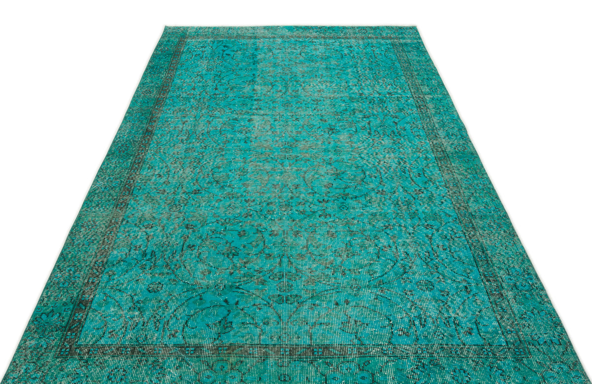 Teal and black distressed traditional rug with an ornate floral medallion pattern on a white background.