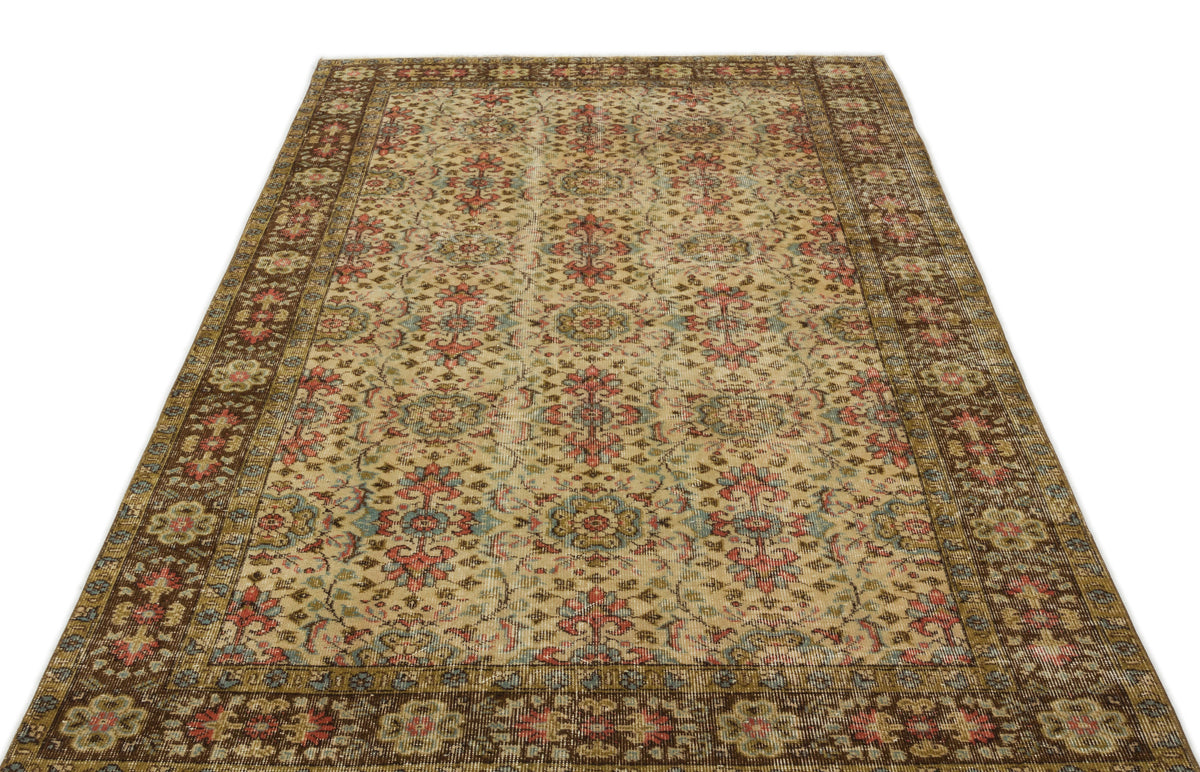 Distressed beige rug with a traditional floral medallion pattern in red, blue, and brown, isolated on a white background.