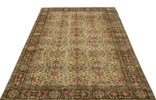 Load image 1 in gallery view. Distressed beige rug with a traditional floral medallion pattern in red, blue, and brown, isolated on a white background.