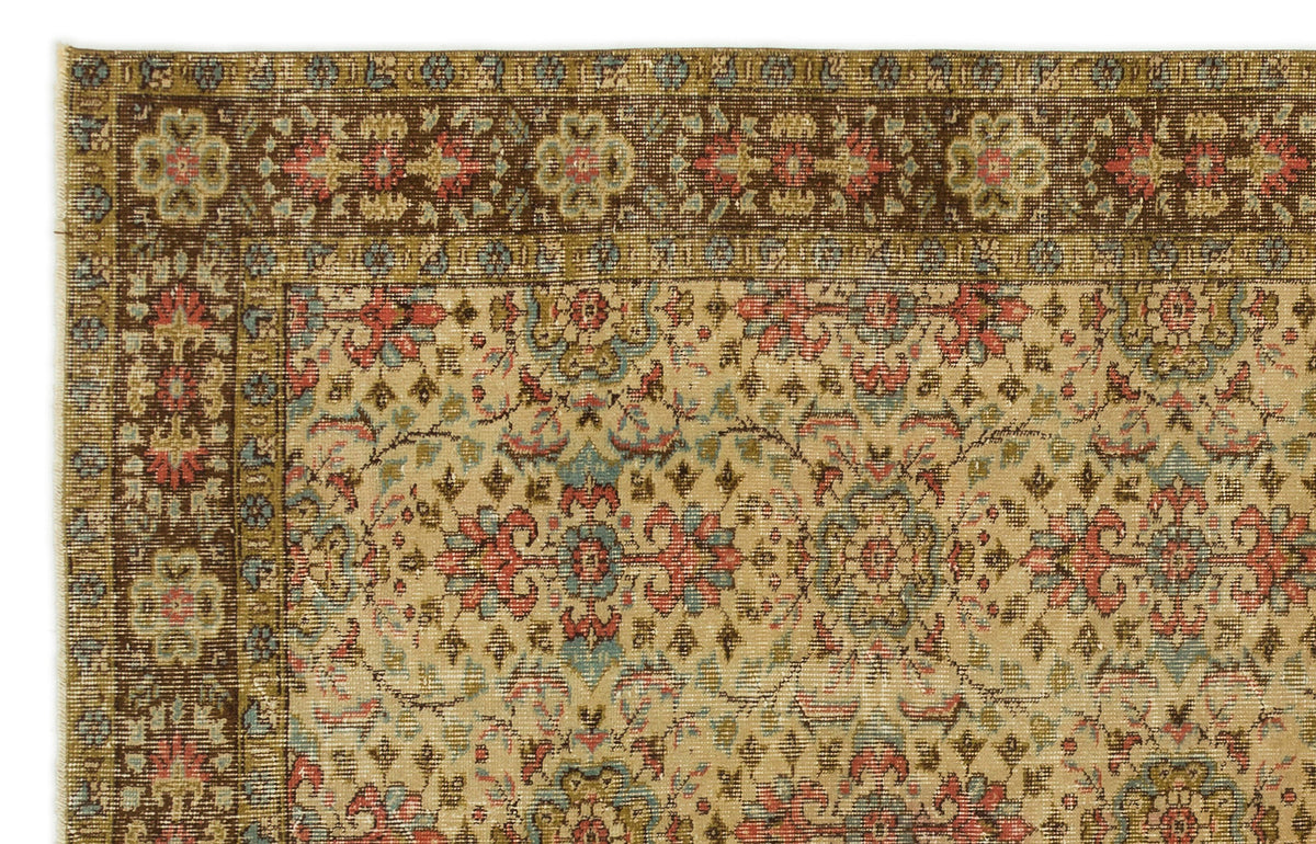 Beige traditional rug with a dark brown border and intricate floral medallion pattern in red, blue, and olive green.