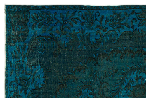 Load image 1 in gallery view. Teal and black rug with a distressed floral border and central medallion pattern.