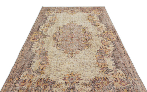 Load image 1 in gallery view. Beige and brown vintage-style rug with a central floral medallion and ornate border on a white background.
