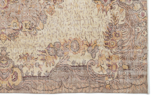 Load image 1 in gallery view. Beige and taupe traditional rug with a distressed floral medallion pattern on a white background.
