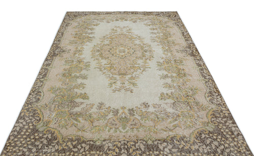 Load image 1 in gallery view. Beige and brown vintage-style rug with a central floral medallion and ornate border on a white background.
