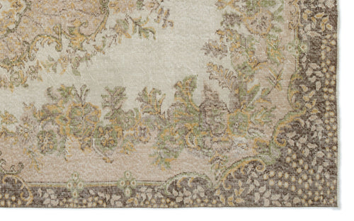 Load image 1 in gallery view. Beige, brown, and sage green traditional rug with a distressed floral medallion pattern on a white background.