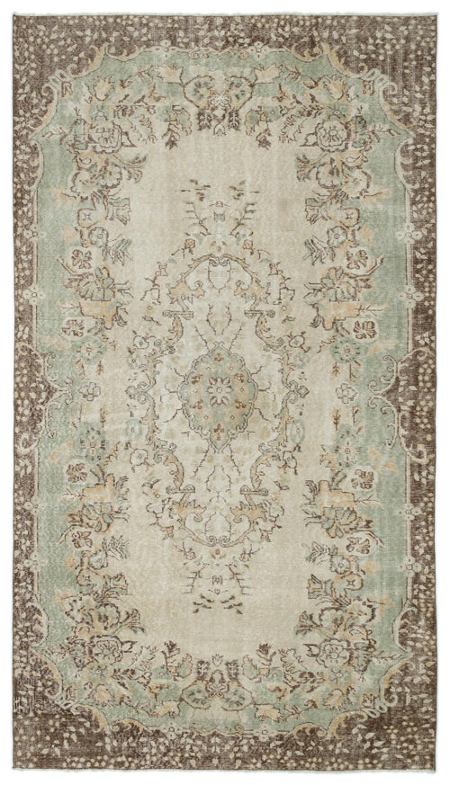 Load image 1 in gallery view. Distressed beige, sage green, and brown rug with a traditional floral medallion pattern and ornate border.