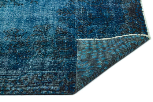 Load image 1 in gallery view. Distressed blue and black vintage-style rug with a folded corner revealing the grey woven backing.