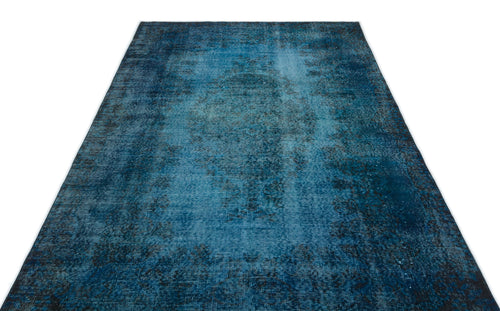 Load image 1 in gallery view. Deep blue distressed area rug with a faded traditional medallion pattern on a white background.