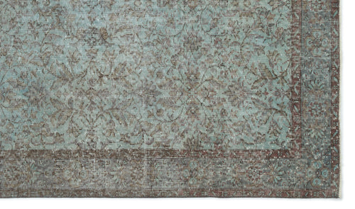 Load image 1 in gallery view. Distressed teal and brown rug with a traditional floral medallion pattern and a wide, ornate border.