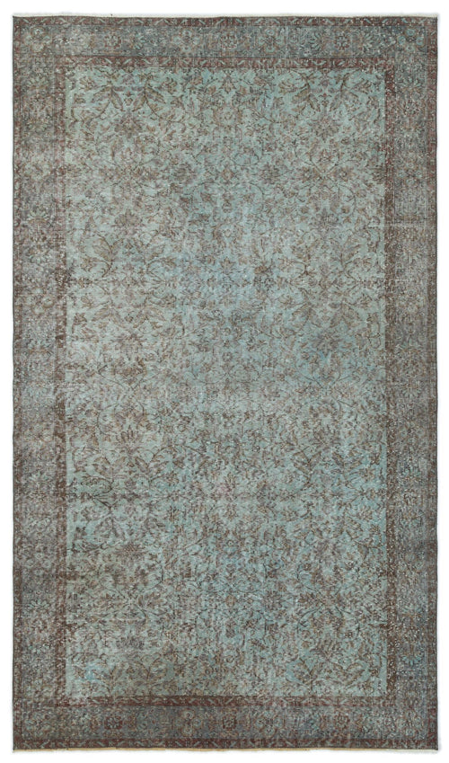 Load image 1 in gallery view. Distressed teal and brown rug with a traditional floral medallion pattern and a wide, ornate border.