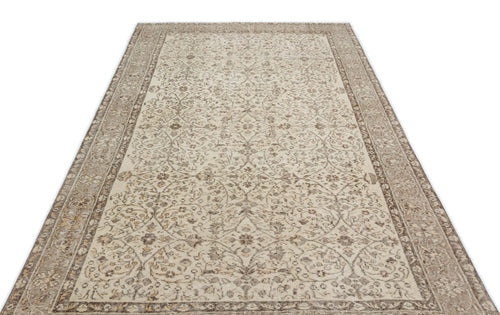 Load image 1 in gallery view. Beige and brown vintage-style rug with a distressed floral medallion pattern and a wide decorative border.