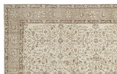 Load image 1 in gallery view. Beige and brown traditional rug with a distressed floral medallion pattern and a detailed border.
