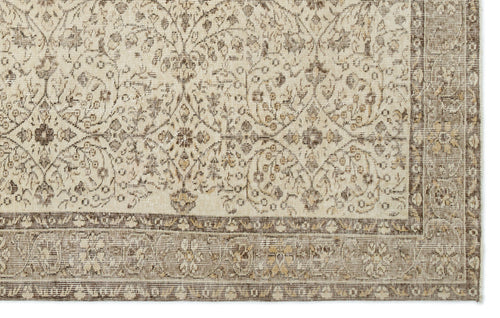 Load image 1 in gallery view. Beige and brown rug with a distressed traditional floral medallion pattern and a wide decorative border.