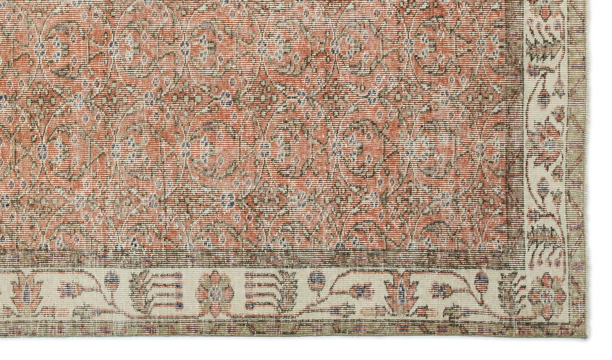 Terracotta and cream traditional rug with a distressed floral medallion pattern and a wide decorative border.