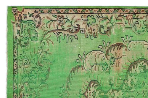 Load image 1 in gallery view. Bright green vintage rug with a brown and black floral border and central botanical motif on a white background.