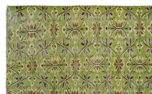 Load image 1 in gallery view. Bright green rug with a repeating brown and beige floral lattice pattern and a distressed finish.