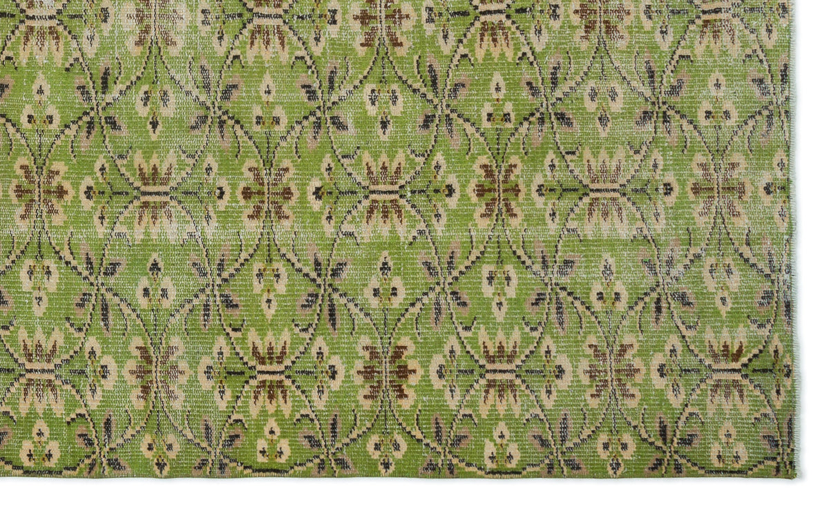 Bright green rug with a repeating beige and dark brown floral trellis pattern.