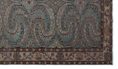 Load image 1 in gallery view. Teal and brown vintage-style rug with a distressed paisley pattern and a geometric border.