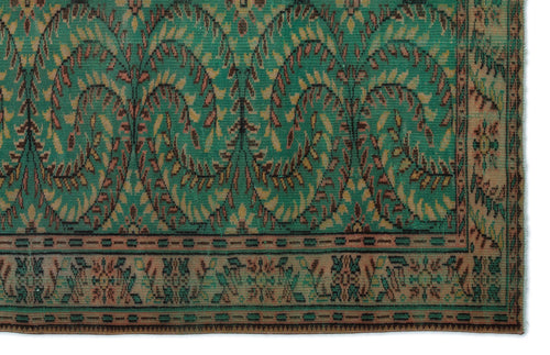 Load image 1 in gallery view. Emerald green rug with a repeating arched leaf pattern in brown and tan, featuring a decorative geometric border.