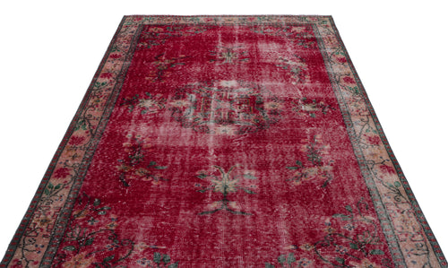 Load image 1 in gallery view. Distressed red rug with a faded central medallion and floral border on a white background.