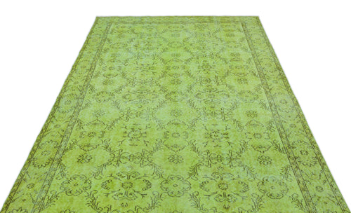 Load image 1 in gallery view. Lime green vintage-style rug with a distressed dark brown floral medallion pattern and a decorative border.
