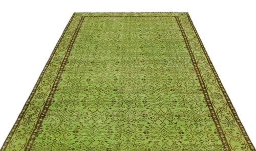 Load image 1 in gallery view. Lime green and brown vintage-style rug with a repeating floral medallion pattern and a decorative border.