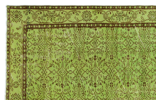 Load image 1 in gallery view. Lime green and brown vintage-style rug with a distressed floral medallion pattern and a decorative border.
