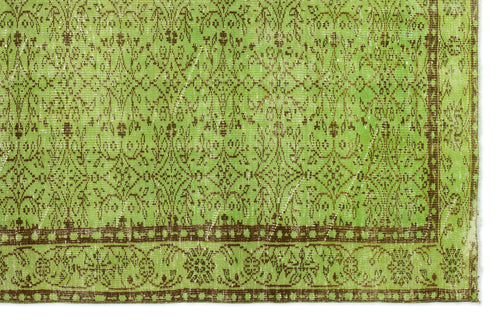 Load image 1 in gallery view. Bright green rug with a distressed brown floral damask pattern and a decorative border.