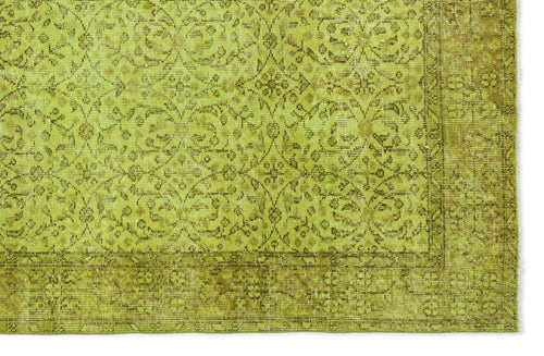 Load image 1 in gallery view. Chartreuse and olive green vintage-style rug with a distressed floral medallion pattern and a wide decorative border.