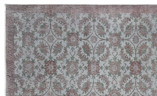 Load image 1 in gallery view. Distressed grey, muted red, and sage green rug with a repeating floral medallion pattern and a solid border.