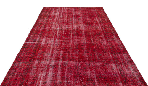 Load image 1 in gallery view. Distressed red vintage rug with a faded traditional floral pattern and white vertical wear lines.