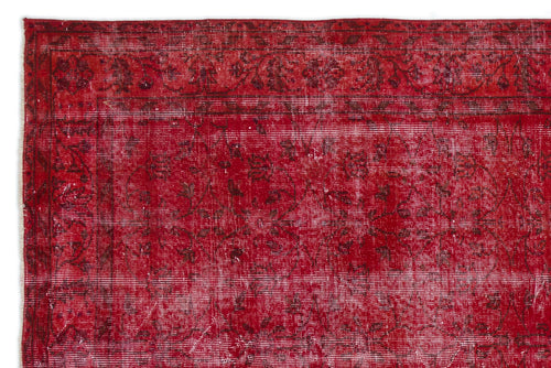 Load image 1 in gallery view. Distressed red rug with a dark floral border and faded traditional medallion pattern on a white background.