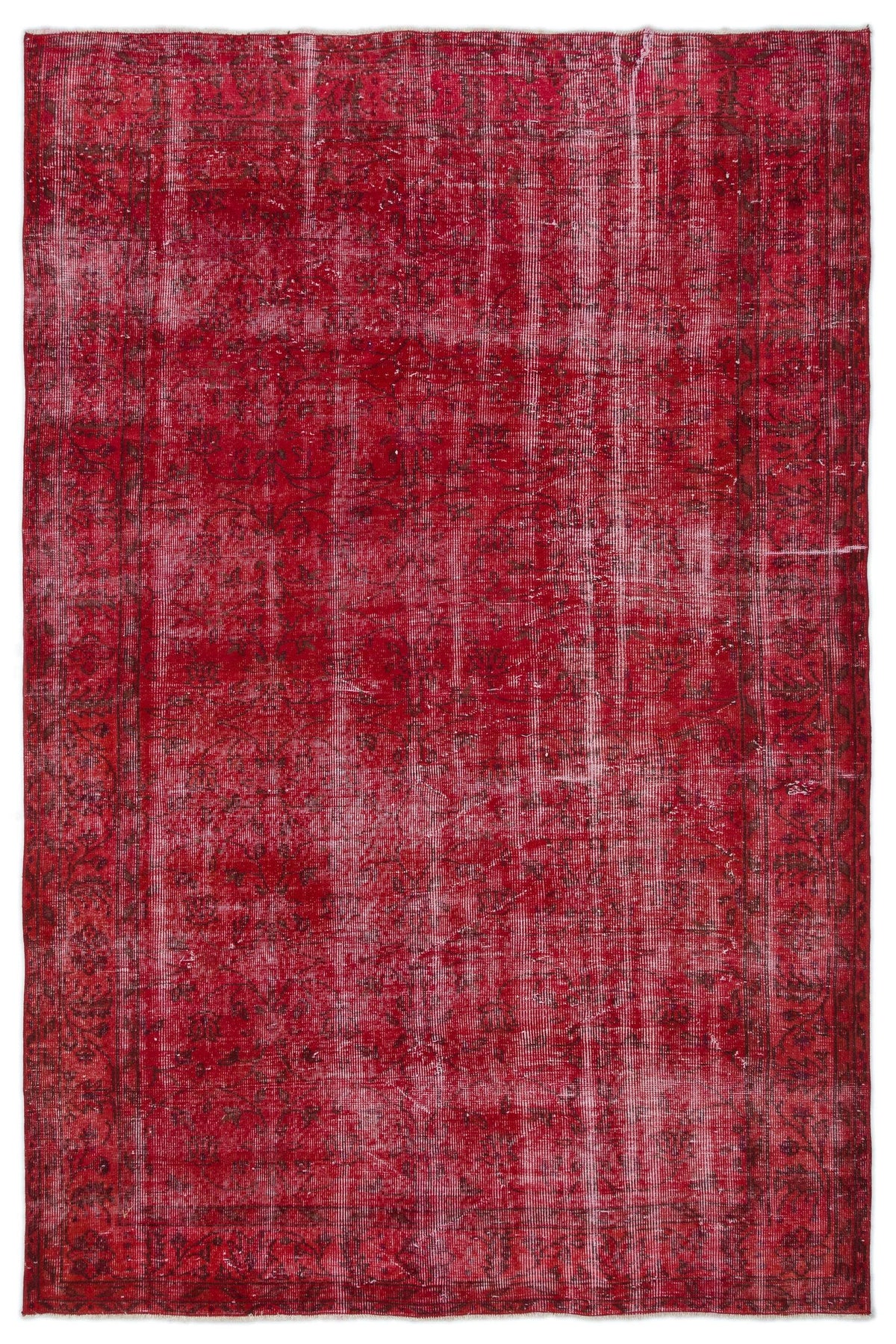 Distressed crimson red vintage rug with a faded floral border and central medallion pattern.