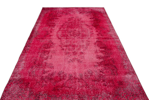Load image 1 in gallery view. Magenta distressed vintage-style rug with a central medallion pattern on a white background.