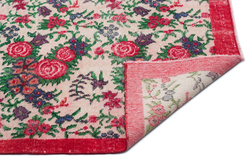 Load image 1 in gallery view. Beige rug with a red, green, and purple floral pattern and a folded corner revealing the underside.