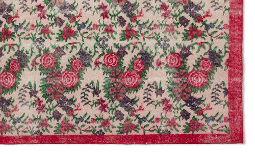 Load image 1 in gallery view. Beige rug with a repeating floral pattern in red, green, and purple, featuring a solid red border.