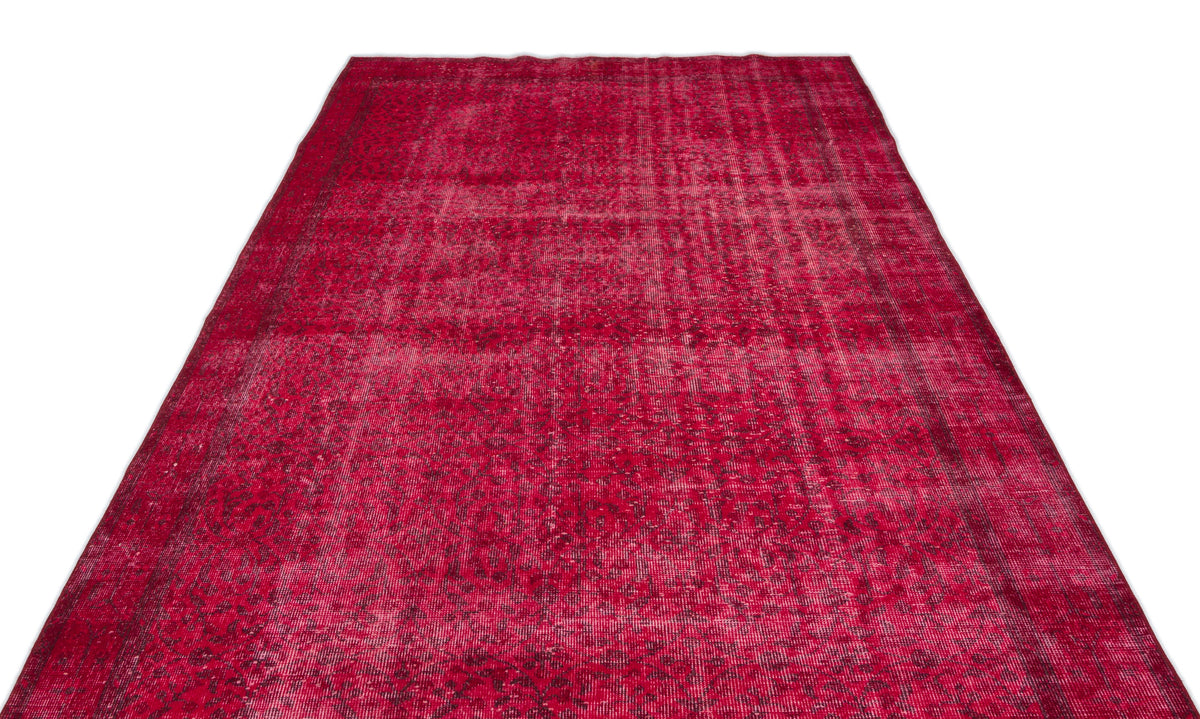 Deep red vintage-style rug with a distressed, faded traditional medallion pattern on a white background.